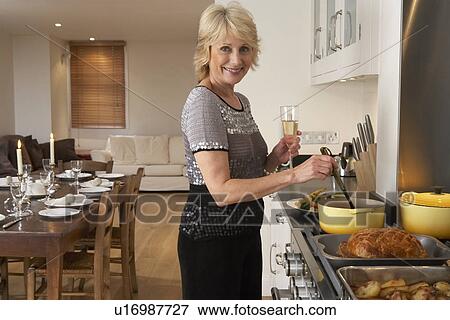 Stock Photo - Woman Preparing Food For A Dinner Party. Fotosearch