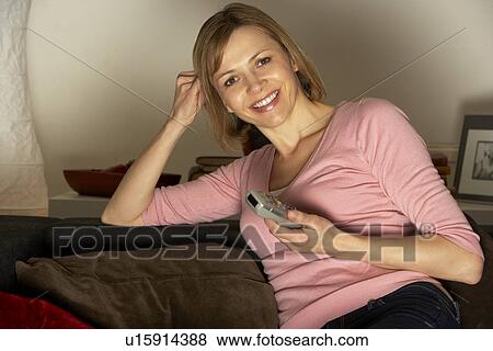 Stock Photo - Woman Relaxing Watching Television. Fotosearch