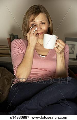 Stock Photo - Woman Relaxing With Cup Of Coffee Watching Television. Fotosearch