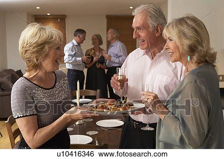 Woman Serving Hors D'oeuvres To Her Guests At A Dinner Party View Large Photo Image Stock Photograph - Woman Serving Hors D'oeuvres To Her Guests At A Dinner Party. Fotosearch