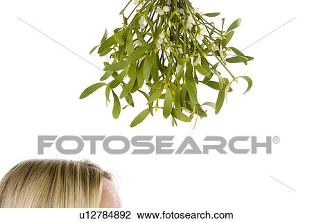 Woman Standing Under Bunch Of Mistletoe Against White Background View Large Photo Image Stock Image - Woman Standing Under Bunch Of Mistletoe Against White Background. Fotosearch