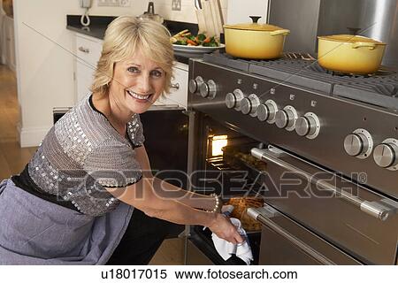 Woman Taking Food Out Of The Oven View Large Photo Image Stock Photography - Woman Taking Food Out Of The Oven. Fotosearch