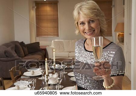 Stock Photography - Woman Throwing A Dinner Party. Fotosearch