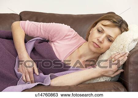 Woman Unwell And Lying On Sofa View Large Photo Image Stock Image - Woman Unwell And Lying On Sofa. Fotosearch