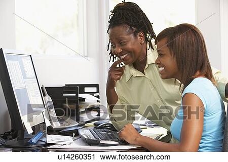 Woman Watching Her Daughter Use A Computer View Large Photo Image Stock Image - Woman Watching Her Daughter Use A Computer. Fotosearch