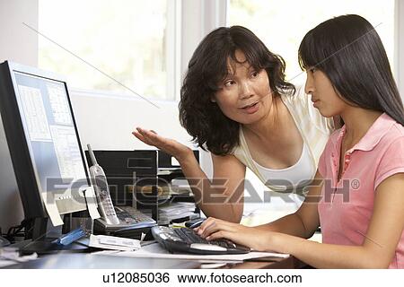 Stock Photograph - Woman Watching Her Daughter Use A Computer. Fotosearch