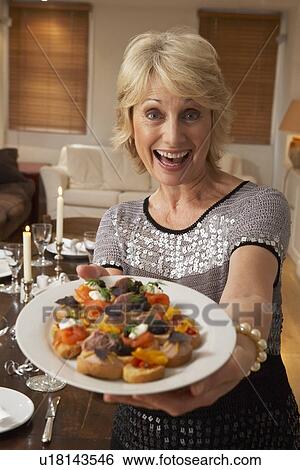 Woman With Hors D'oeuvres For A Dinner Party View Large Photo Image Stock Photograph - Woman With Hors D'oeuvres For A Dinner Party. Fotosearch