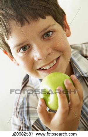 Young Boy Eating Apple View Large Photo Image Stock Photo - Young Boy Eating Apple. Fotosearch