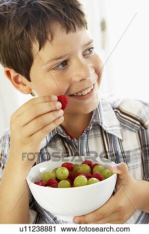 Young Boy Eating Bowl Of Fresh Fruit View Large Photo Image Stock Image - Young Boy Eating Bowl Of Fresh Fruit. Fotosearch