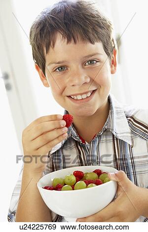Young Boy Eating Bowl Of Fresh Fruit View Large Photo Image Stock Photo - Young Boy Eating Bowl Of Fresh Fruit. Fotosearch