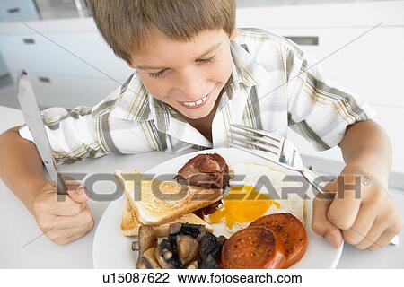 Young Boy Eating Unhealthy Fried Breakfast View Large Photo Image Stock Image - Young Boy Eating Unhealthy Fried Breakfast. Fotosearch