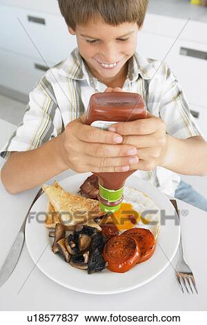 Young Boy Eating Unhealthy Fried Breakfast View Large Photo Image Stock Photo - Young Boy Eating Unhealthy Fried Breakfast. Fotosearch