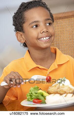 Young Boy Enjoying A Meal At Home View Large Photo Image Stock Photography - Young Boy Enjoying A Meal At Home. Fotosearch