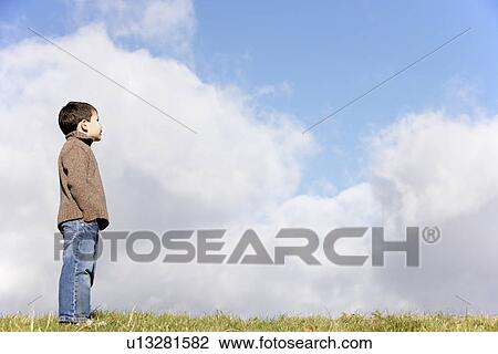 Young Boy Standing In The Park View Large Photo Image Stock Image - Young Boy Standing In The Park. Fotosearch