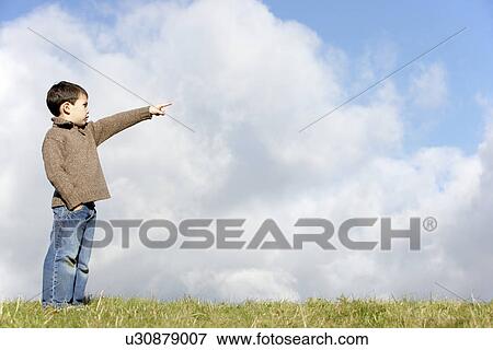 Young Boy Standing In The Park View Large Photo Image Stock Photo - Young Boy Standing In The Park. Fotosearch