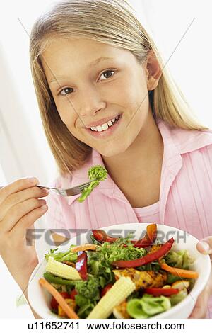 Young Girl Eating Fresh Salad View Large Photo Image Stock Image - Young Girl Eating Fresh Salad. Fotosearch