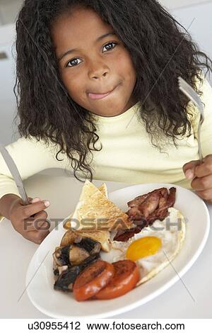 Young Girl Eating Unhealthy Breakfast View Large Photo Image Stock Image - Young Girl Eating Unhealthy Breakfast. Fotosearch