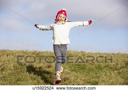 Picture - Young Girl Running In The Park. Fotosearch