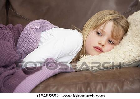 Young Girl Unwell Lying On Sofa View Large Photo Image Stock Image - Young Girl Unwell Lying On Sofa. Fotosearch