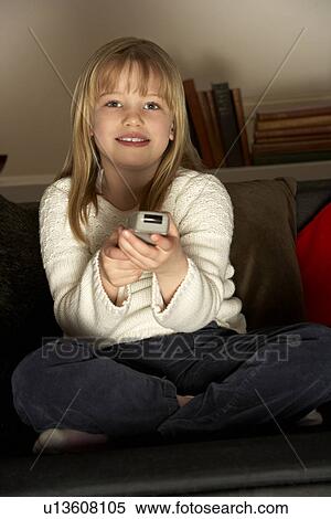 Stock Photography - Young Girl Using Remote Control. Fotosearch