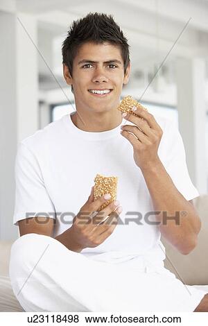 Young Man Eating A Brown Bread Roll View Large Photo Image Stock Photo - Young Man Eating A Brown Bread Roll. Fotosearch