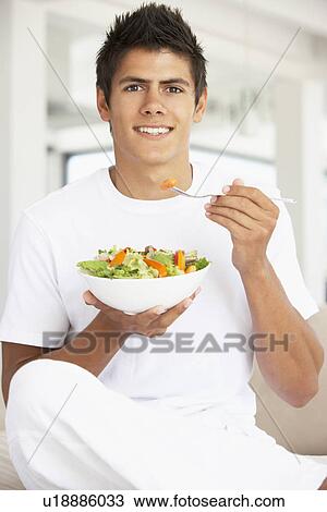 Young Man Eating A Salad View Large Photo Image Stock Image - Young Man Eating A Salad. Fotosearch