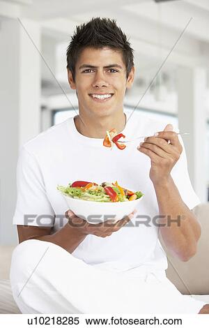 Young Man Eating A Salad View Large Photo Image Stock Photography - Young Man Eating A Salad. Fotosearch