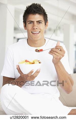 Young Man Eating Fresh Fruit Salad View Large Photo Image Stock Image - Young Man Eating Fresh Fruit Salad. Fotosearch