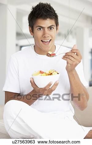 Young Man Eating Fresh Fruit Salad View Large Photo Image Stock Image - Young Man Eating Fresh Fruit Salad. Fotosearch