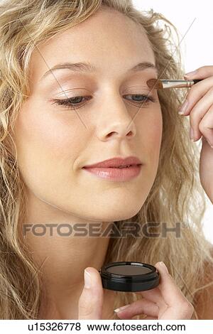 Young Woman Applying Make-Up View Large Photo Image Stock Photo - Young Woman Applying Make-Up. Fotosearch