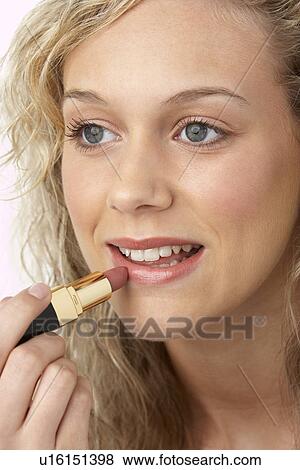 Stock Photo - Young Woman Applying Make-Up. Fotosearch