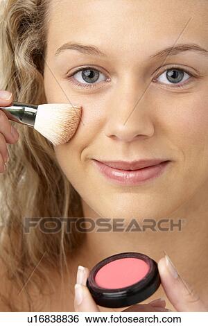 Stock Photograph - Young Woman Applying Make-Up. Fotosearch