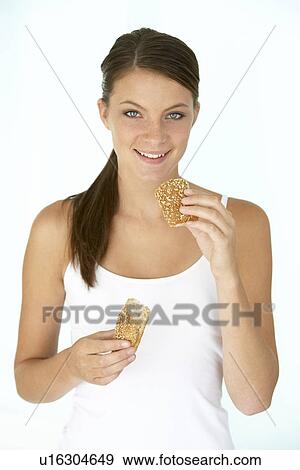 Young Woman Eating A Brown Bread Roll View Large Photo Image Stock Photo - Young Woman Eating A Brown Bread Roll. Fotosearch