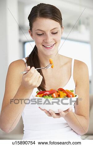 Picture - Young Woman Eating A Healthy Salad. Fotosearch