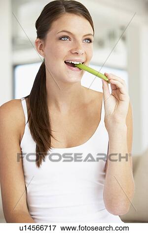 Young Woman Eating Celery Sticks View Large Photo Image Stock Photo - Young Woman Eating Celery Sticks. Fotosearch