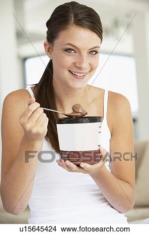 Young Woman Eating Chocolate Ice-Cream View Large Photo Image Picture - Young Woman Eating Chocolate Ice-Cream. Fotosearch