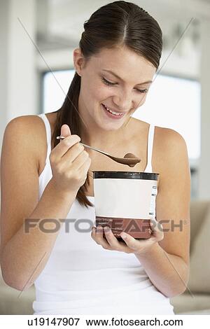 Young Woman Eating Chocolate Ice-Cream View Large Photo Image Stock Photo - Young Woman Eating Chocolate Ice-Cream. Fotosearch