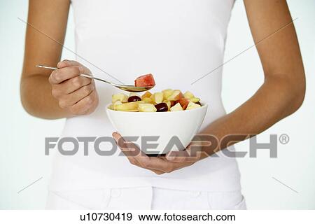 Young Woman Eating Fresh Fruit Salad View Large Photo Image Stock Photo - Young Woman Eating Fresh Fruit Salad. Fotosearch