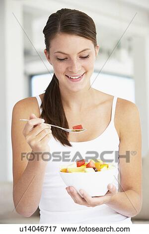 Young Woman Eating Fresh Fruit Salad View Large Photo Image Stock Photo - Young Woman Eating Fresh Fruit Salad. Fotosearch