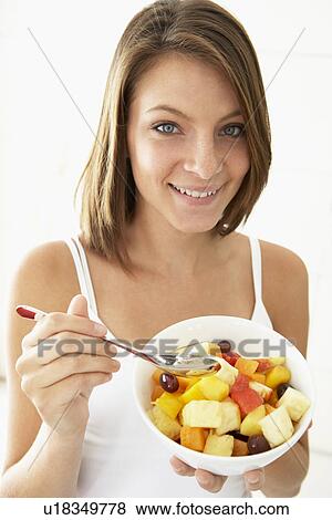 Young Woman Eating Fresh Fruit Salad View Large Photo Image Stock Photo - Young Woman Eating Fresh Fruit Salad. Fotosearch
