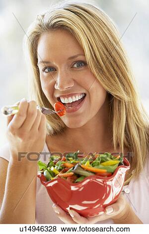 Young Woman Eating Fresh Salad View Large Photo Image Stock Photo - Young Woman Eating Fresh Salad. Fotosearch