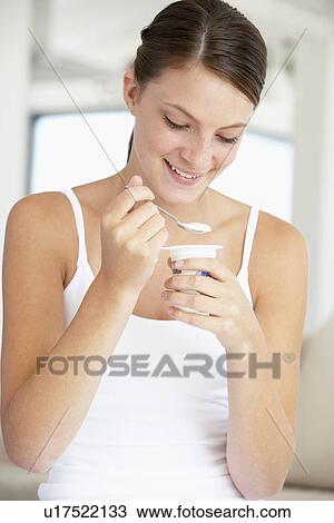 Young Woman Eating Yogurt View Large Photo Image Stock Image - Young Woman Eating Yogurt. Fotosearch