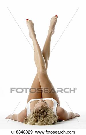 Young Woman Lying Down With Her Legs In The Air View Large Photo Image Stock Photo - Young Woman Lying Down With Her Legs In The Air. Fotosearch
