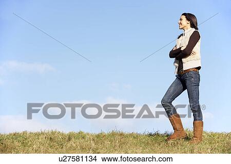 Picture - Young Woman Standing In Park. Fotosearch
