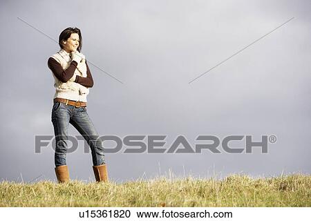 Young Woman Standing In Park View Large Photo Image Stock Image - Young Woman Standing In Park. Fotosearch