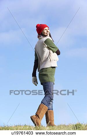 Stock Image - Young Woman Standing In Park. Fotosearch