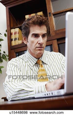 Stock Photo - Businessman using a laptop. Fotosearch