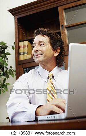 Stock Photo - Businessman using a laptop. Fotosearch