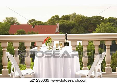 Stock Photography - Champagne bottle and two champagne flutes on the table. Fotosearch