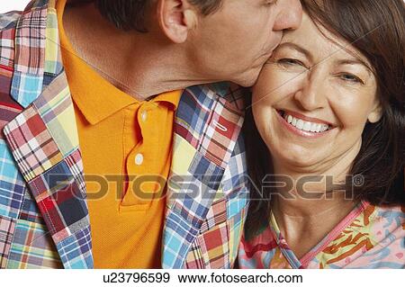 Stock Photo - Close-up of a mature man kissing a mature woman. Fotosearch